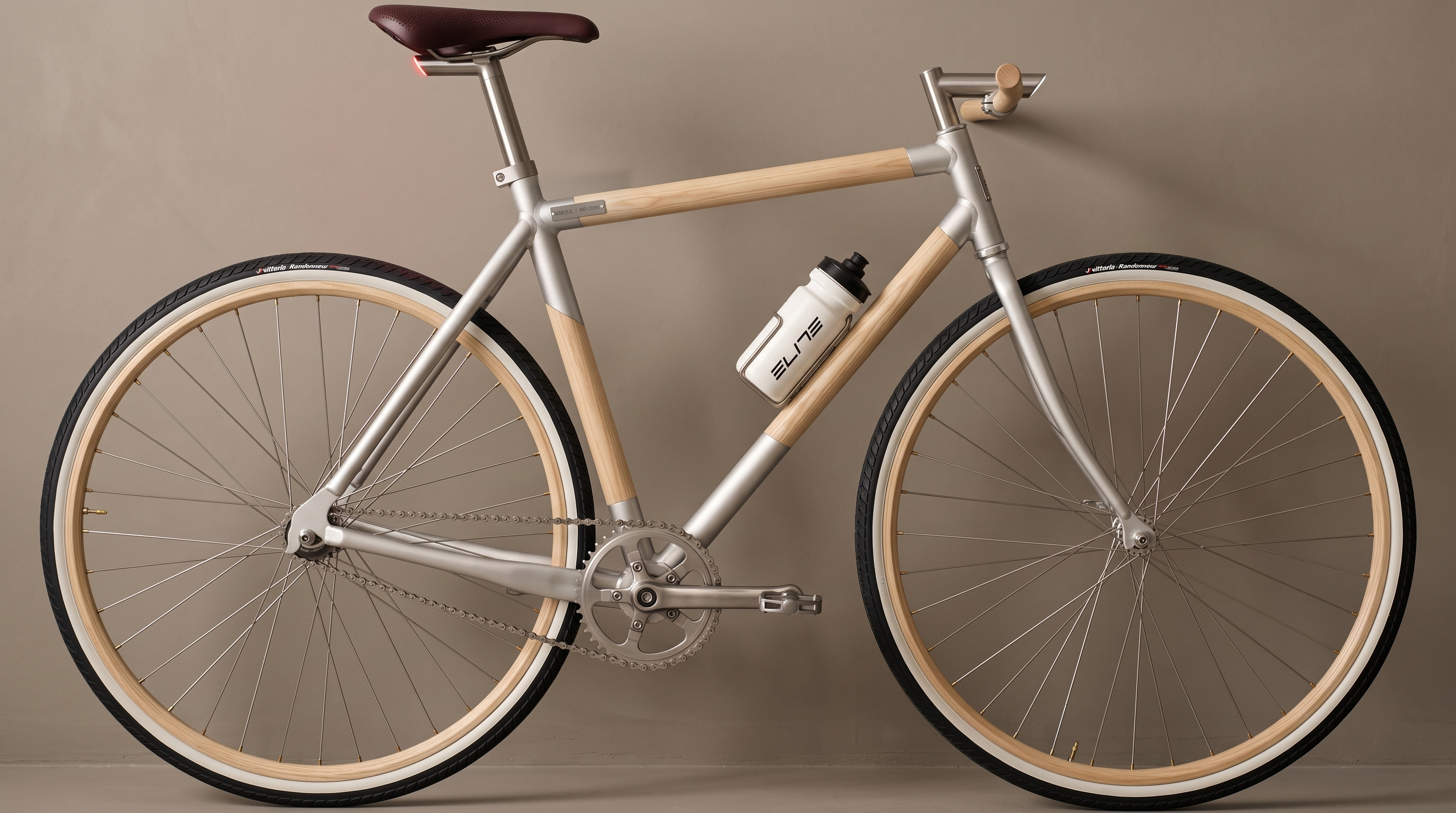 ESE-OUL concept bicycle in full profile showcasing solid ash frame tubes, wooden rims, and bead-blasted metal lugs
