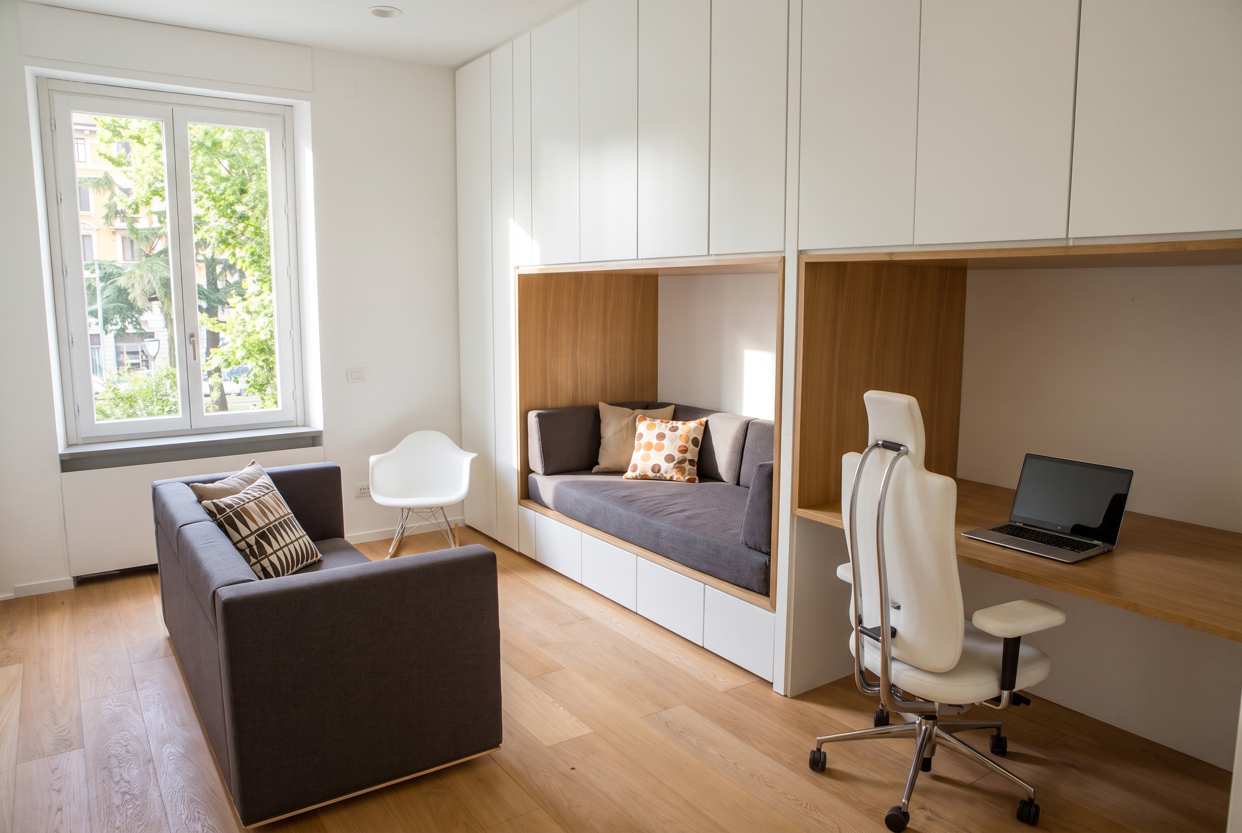 Study and reading lounge with full-height white cabinetry incorporating bespoke oak daybed alcove and integrated workspace