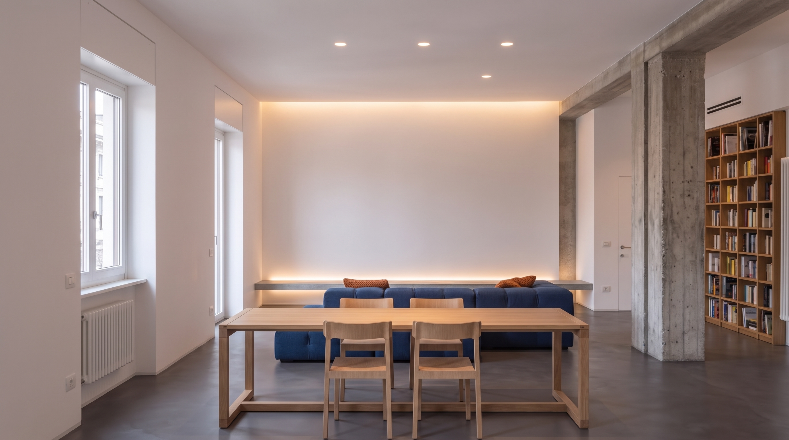 S041: Minimalist Milan apartment featuring concrete columns and Klein blue heating pipes